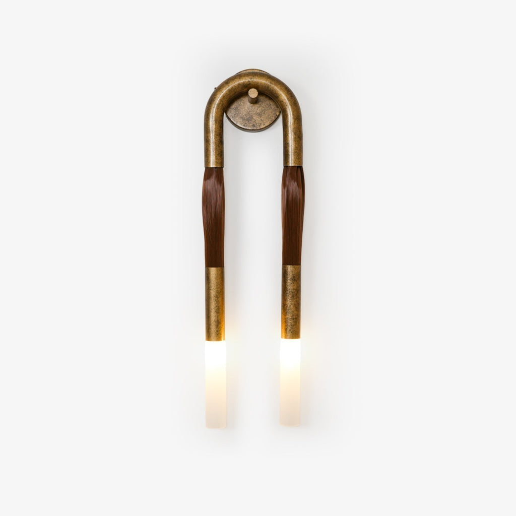 Modern horsehair iron and glass wall sconce mounted on an interior wall