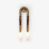 Modern horsehair iron and glass wall sconce mounted on an interior wall