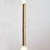 yellow travertine column wall sconce with dark walnut wood