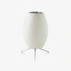 Modern tripod table lamp with a white shade and chrome steel base
