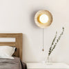 modern yellow travertine lunar eclipse wall sconce