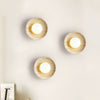 modern yellow travertine lunar eclipse wall sconce