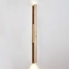 yellow travertine column wall sconce with dark walnut wood