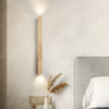 yellow travertine column wall sconce with dark walnut wood